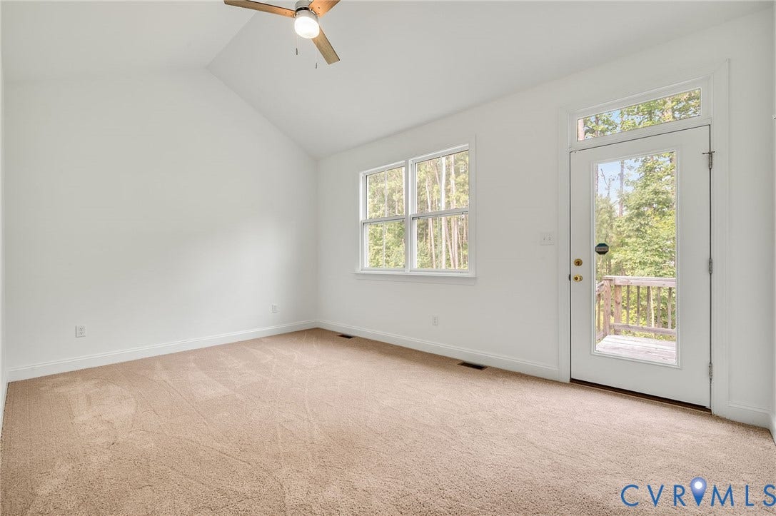 7130 Maple Summit Lane, Moseley, VA 23120 Bright interior space featuring a vaulted ceiling and a ceiling fan with integrated lighting