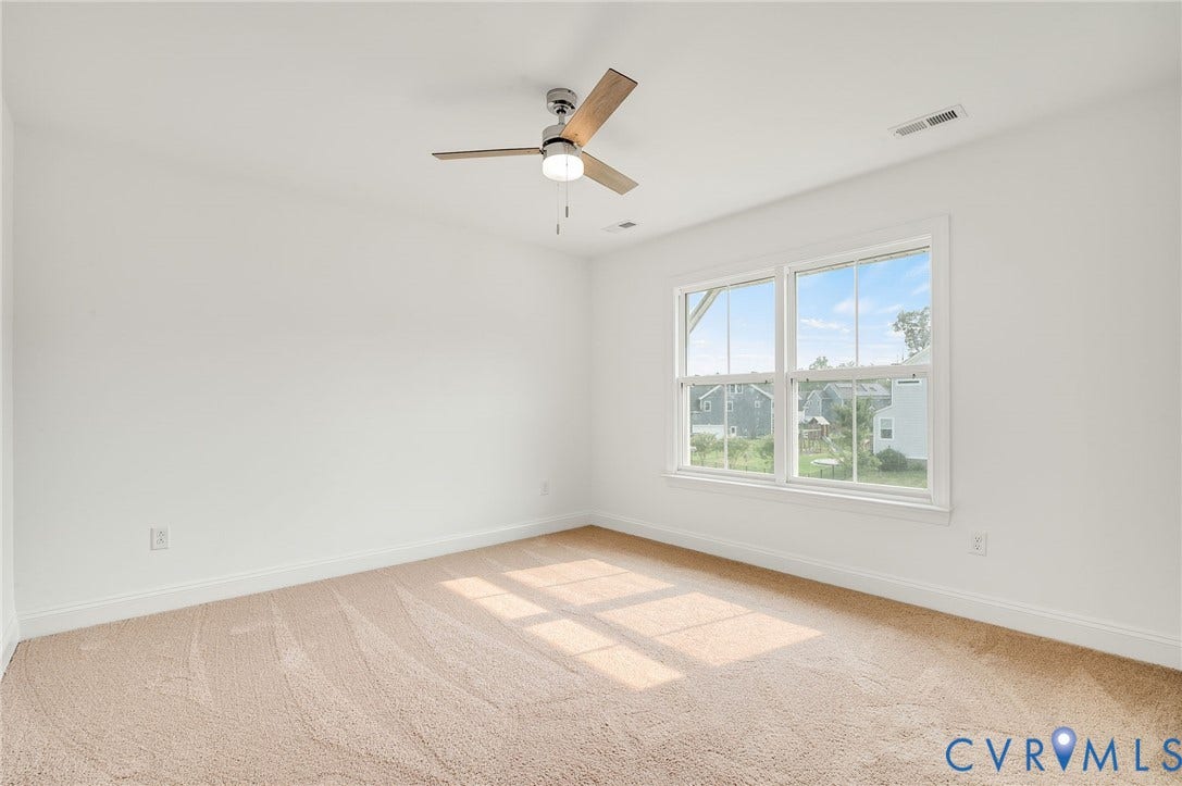 7130 Maple Summit Lane, Moseley, VA 23120 Carpeted room featuring a ceiling fan with light, white trim, and two large double-hung windows