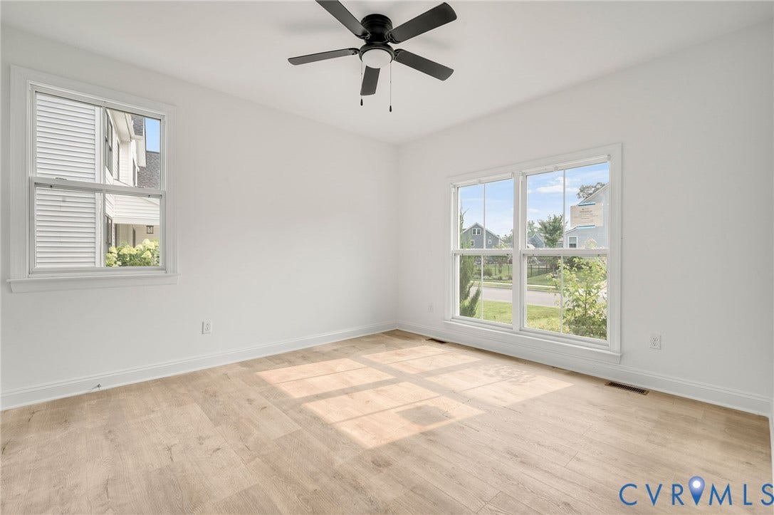 7130 Maple Summit Lane, Moseley, VA 23120 Spacious room featuring light wood-finish flooring, white walls, and a black ceiling fan