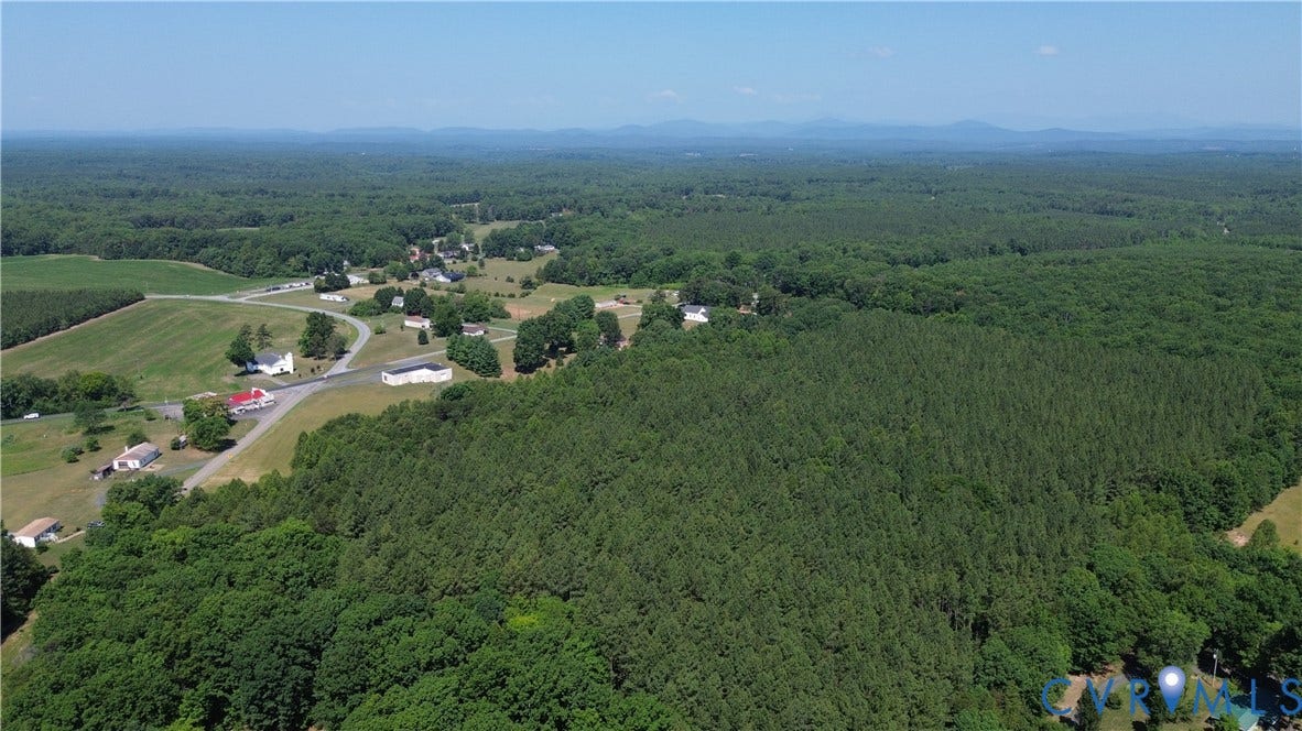 00 Glenmore Road, Howardsville, VA 24562 Expansive wooded acreage featuring dense tree cover and a clear blue sky