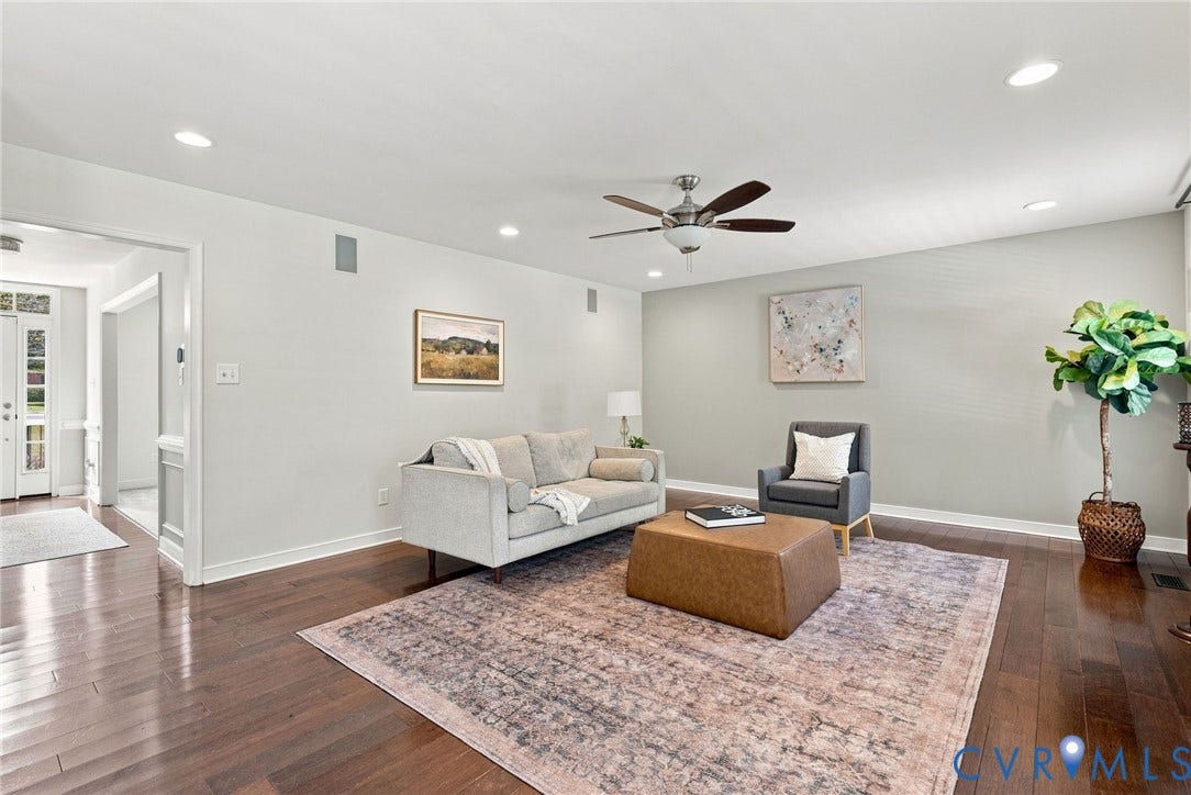 Hardwood flooring throughout, recessed lighting, ceiling fan, and a wide entryway