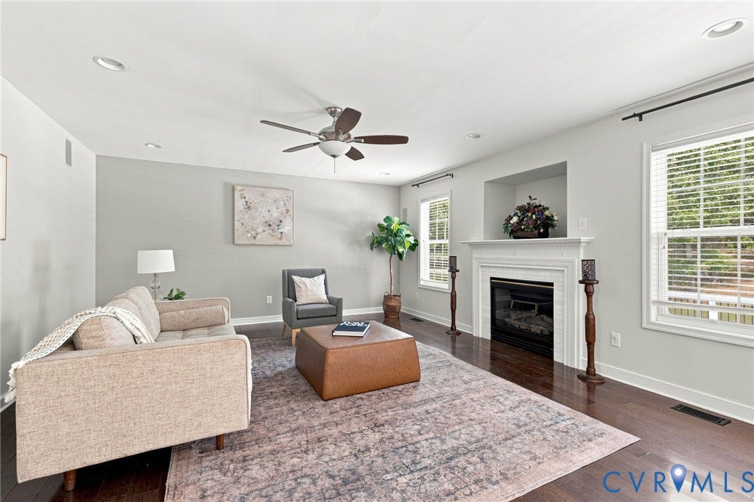 Hardwood-style flooring throughout, recessed lighting, and a ceiling fan with integrated light