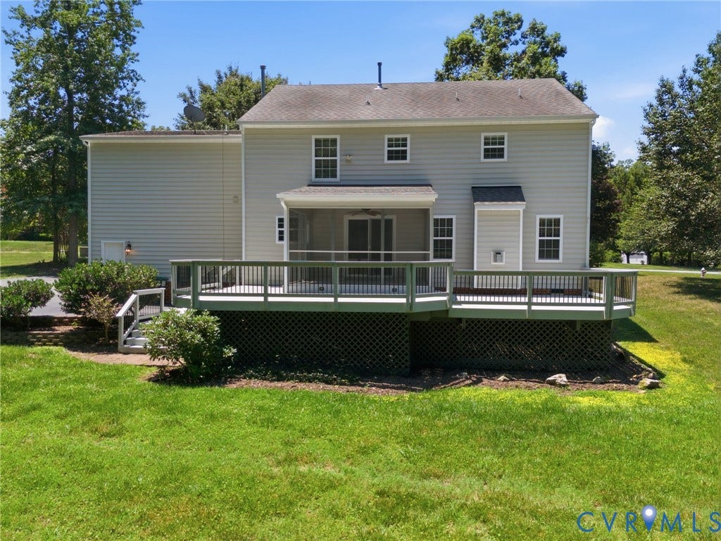 Rear exterior featuring a screened porch, expansive outdoor deck, and a multi-level structure with light-colored siding