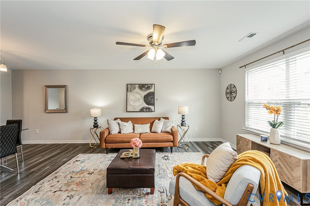1324 Stone Ridge Park Loop, Henrico, VA 23228 Spacious living area featuring wood-finish flooring, light-toned walls, and a ceiling fan with integrated lighting