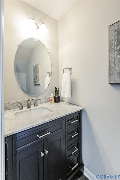 1324 Stone Ridge Park Loop, Henrico, VA 23228 Bathroom vanity with dark wood cabinetry, a white countertop, and an undermount sink