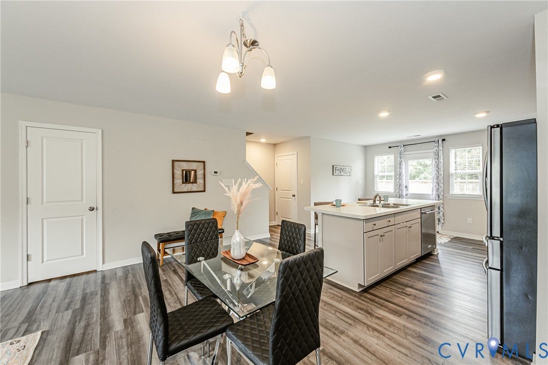 1324 Stone Ridge Park Loop, Henrico, VA 23228 Open-concept living space featuring wood-finish flooring, a kitchen island with integrated sink, stainless steel dishwasher, and recessed lighting