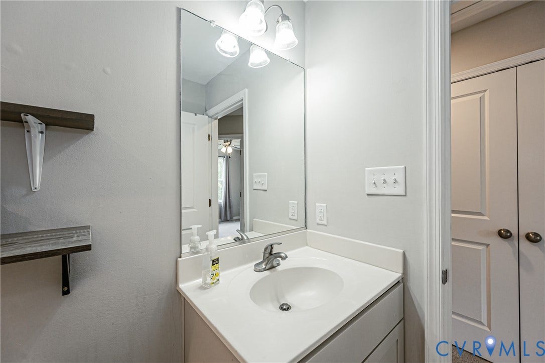 1324 Stone Ridge Park Loop, Henrico, VA 23228 Bathroom vanity with an integrated sink, polished chrome faucet, and overhead three-bulb light fixture