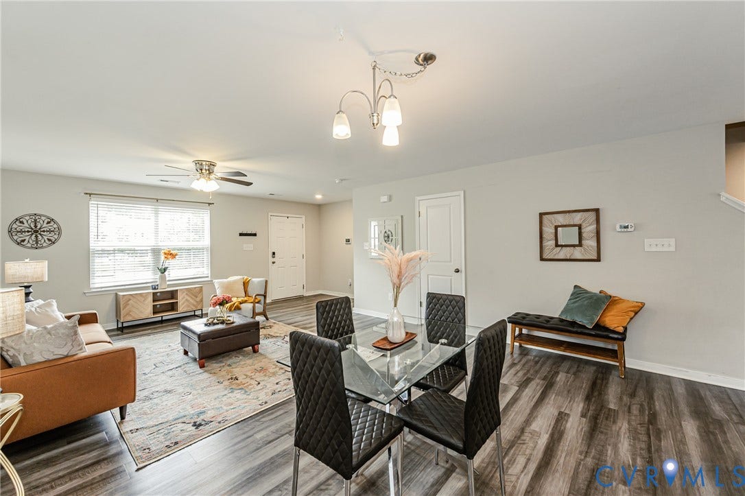 1324 Stone Ridge Park Loop, Henrico, VA 23228 Open-concept living and dining area featuring wood-finish flooring, light gray wall paint, and white trim