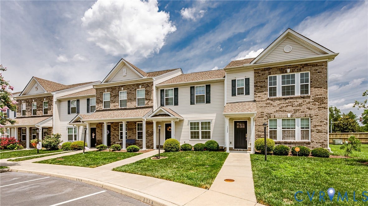 1324 Stone Ridge Park Loop, Henrico, VA 23228 Townhome exteriors featuring brick and siding facades, gabled roofs, and manicured front lawns