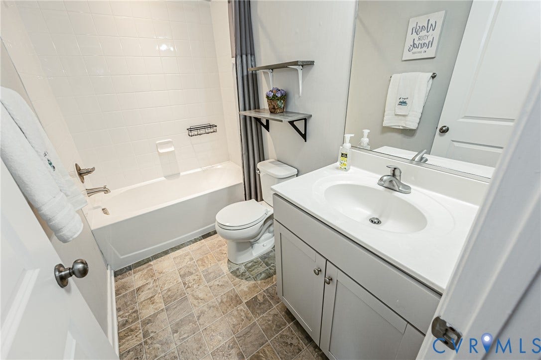 1324 Stone Ridge Park Loop, Henrico, VA 23228 Bathroom featuring a white vanity with integrated sink, chrome faucet, and a large wall-mounted mirror