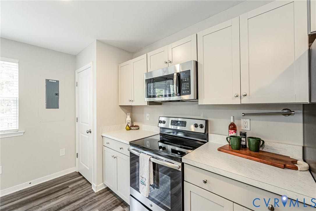 1324 Stone Ridge Park Loop, Henrico, VA 23228 Kitchen featuring light-toned cabinetry with brushed nickel hardware, stainless steel appliances, and a wood-finish flooring