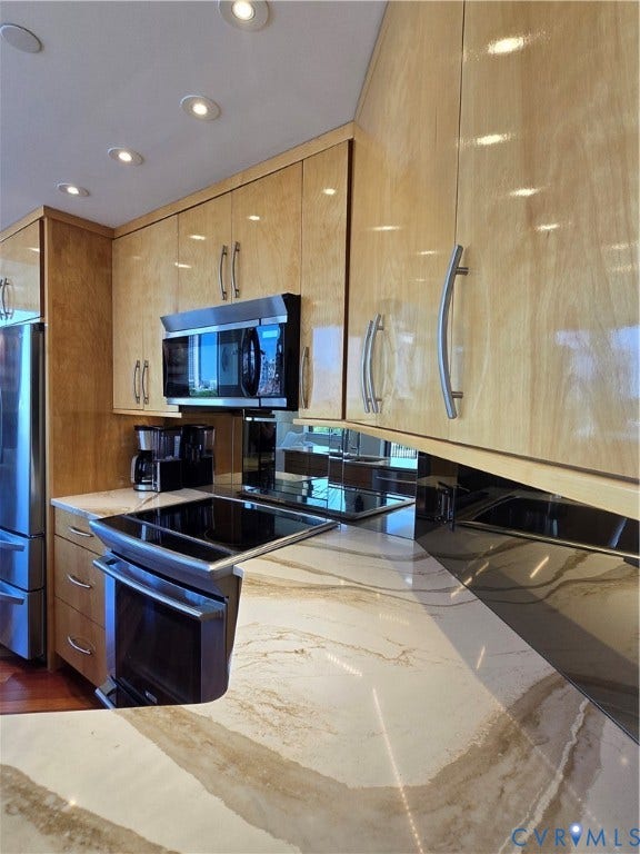 1101 Haxall Point, #815, Richmond, VA 23219 Open-concept kitchen featuring light wood-finish cabinetry with stainless steel hardware, a white and brown patterned countertop, stainless steel appliances, and ceiling recessed lighting