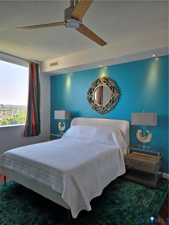 1101 Haxall Point, #815, Richmond, VA 23219 Bedroom featuring a vibrant accent wall with recessed lighting, a modern ceiling fan, and hardwood flooring with a decorative area rug