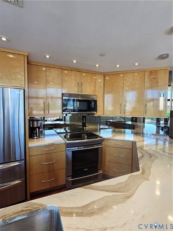 1101 Haxall Point, #815, Richmond, VA 23219 Contemporary kitchen featuring light wood cabinetry and stainless steel appliances