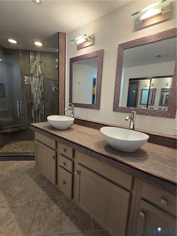 1101 Haxall Point, #815, Richmond, VA 23219 Dual vessel sinks set atop a wood-finish vanity with ample storage
