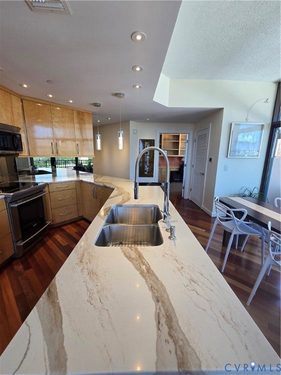 1101 Haxall Point, #815, Richmond, VA 23219 Spacious kitchen featuring an extended island with a double stainless steel sink and a contemporary faucet