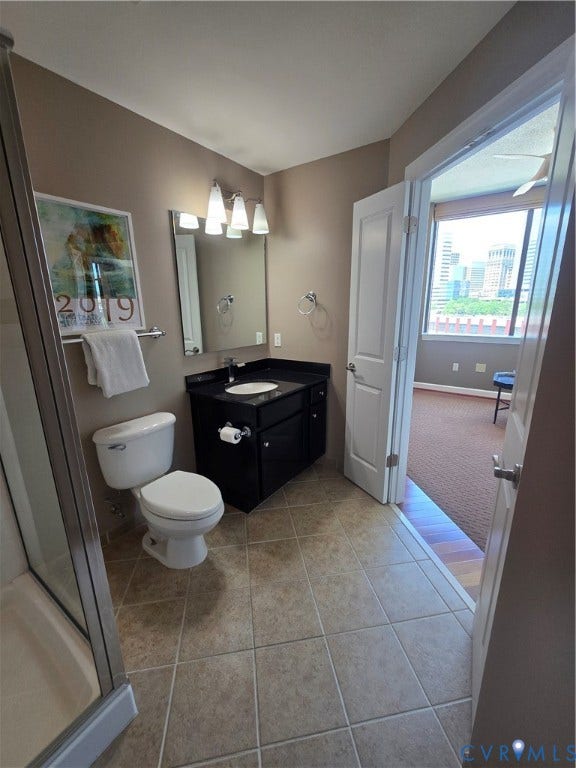 1101 Haxall Point, #815, Richmond, VA 23219 Bathroom featuring a dark wood-finish vanity with a black countertop, a white toilet, and a stand-up shower with a glass enclosure