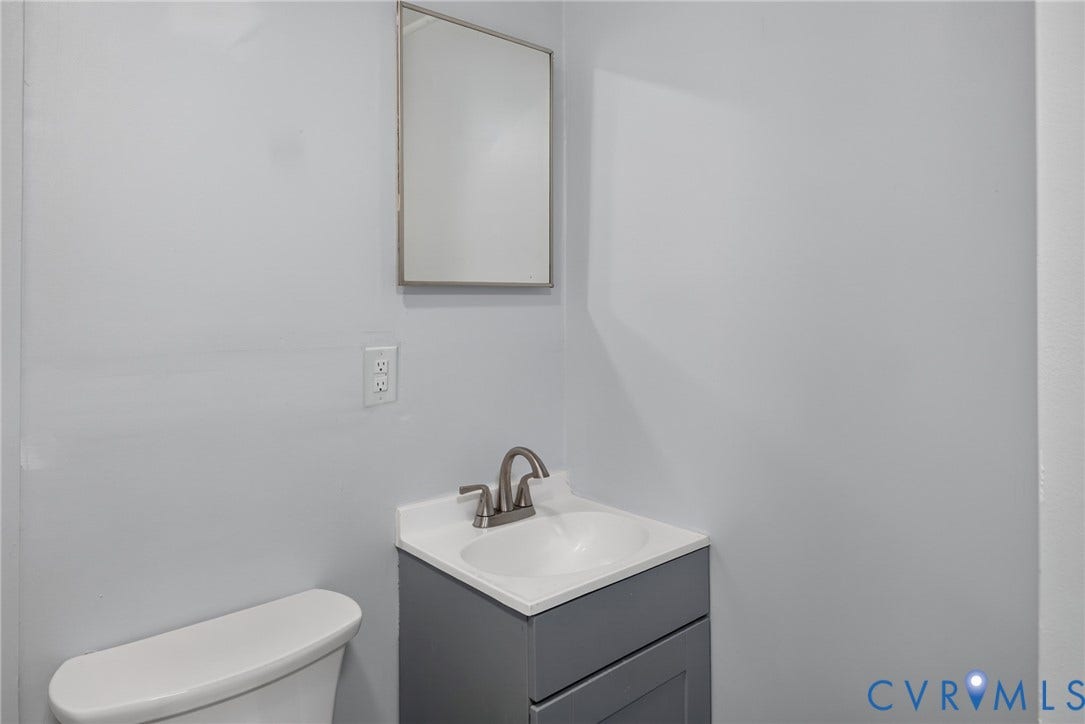 13070 Auburn Mill Road, Glen Allen, VA 23059 Vanity with a white countertop and integrated sink, brushed nickel faucet, and gray cabinetry