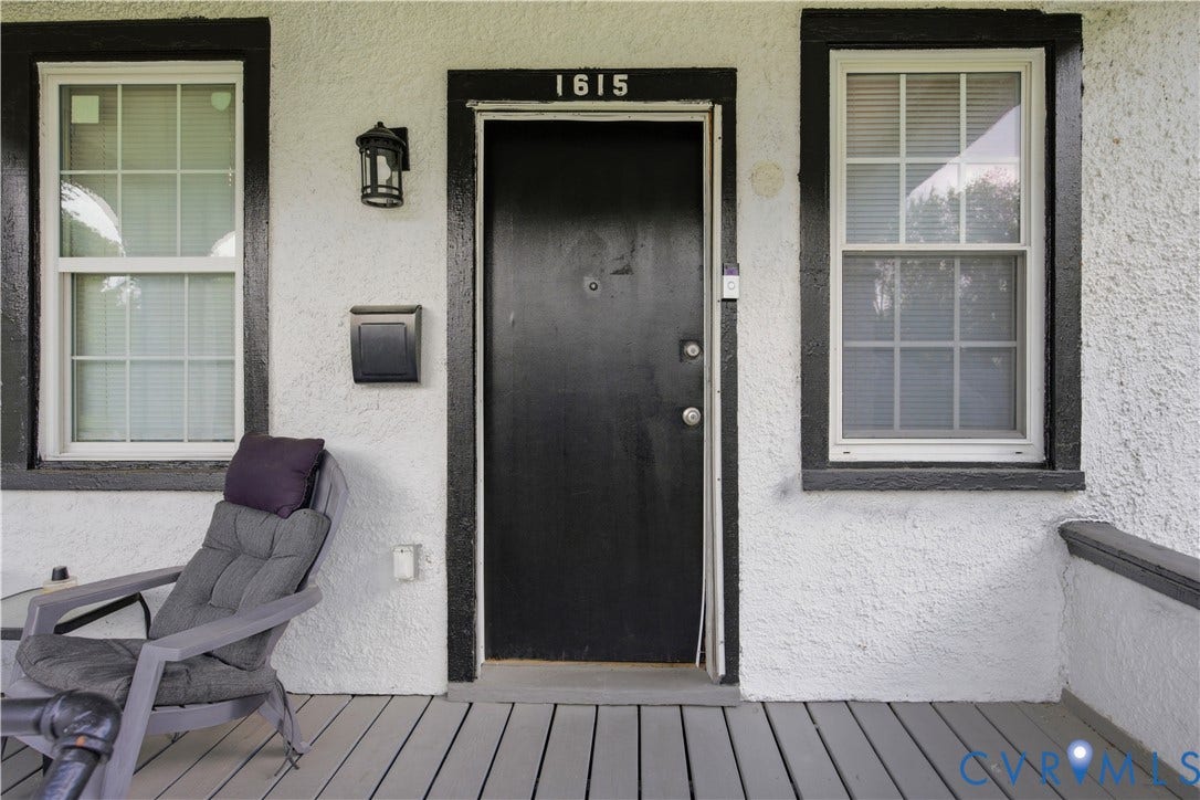 1615 N 19th Street, Richmond, VA 23223 Front entry featuring a black door with contrasting white stucco siding and black trim