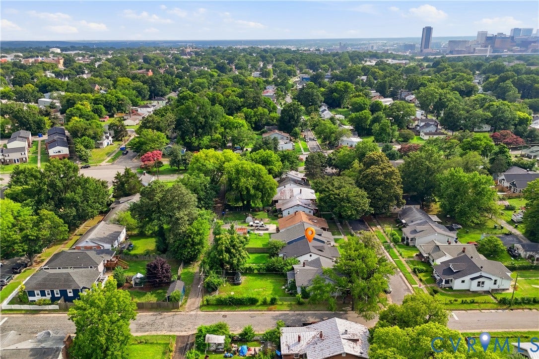 1615 N 19th Street, Richmond, VA 23223 Residential streetscape featuring mature tree canopy, established homes, and urban background