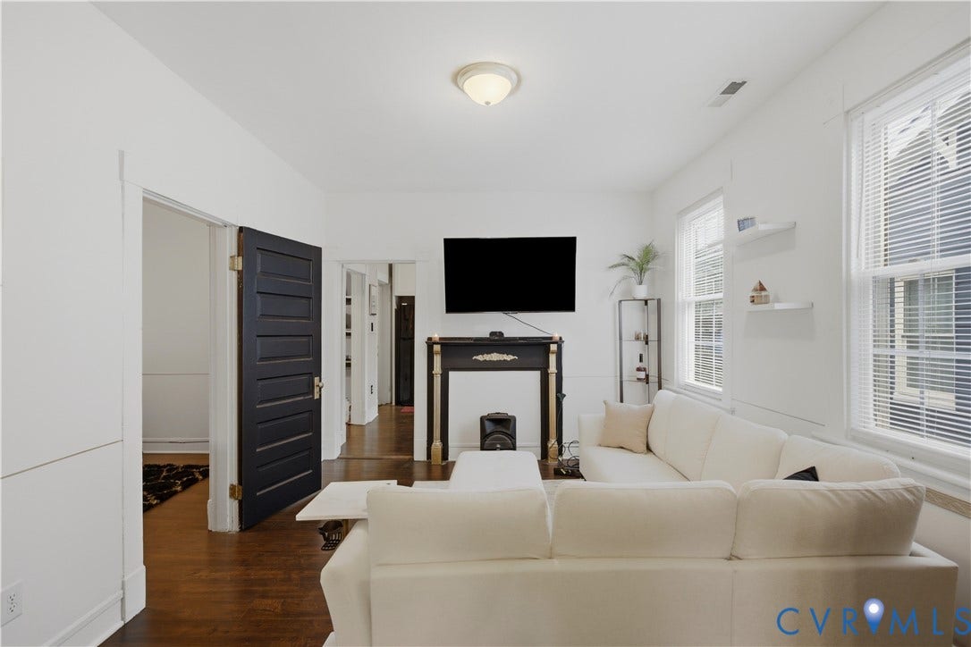 1615 N 19th Street, Richmond, VA 23223 Living area featuring rich wood-finish flooring and multiple windows with blinds
