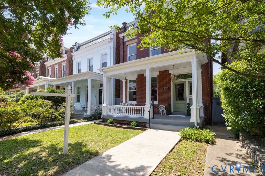 3135 Floyd Avenue, Museum District, Richmond, VA 23221 Brick facade townhome with a full-width covered porch, white balustrade, and a light green entry door