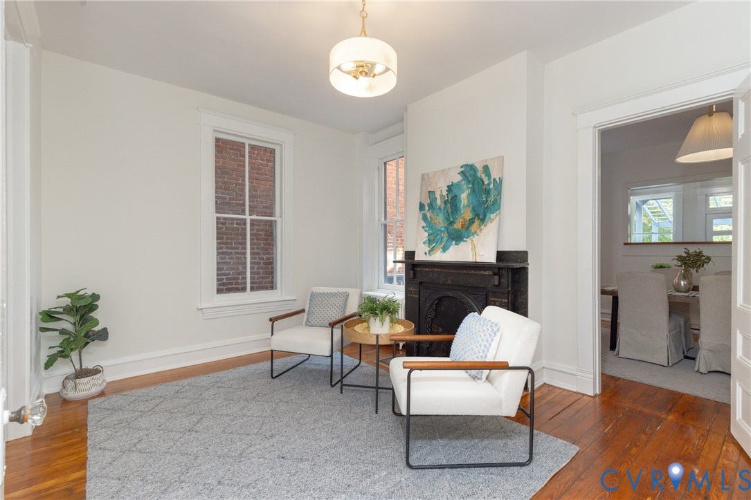 3135 Floyd Avenue, Museum District, Richmond, VA 23221 Hardwood flooring, white walls, and a fireplace with a black mantel