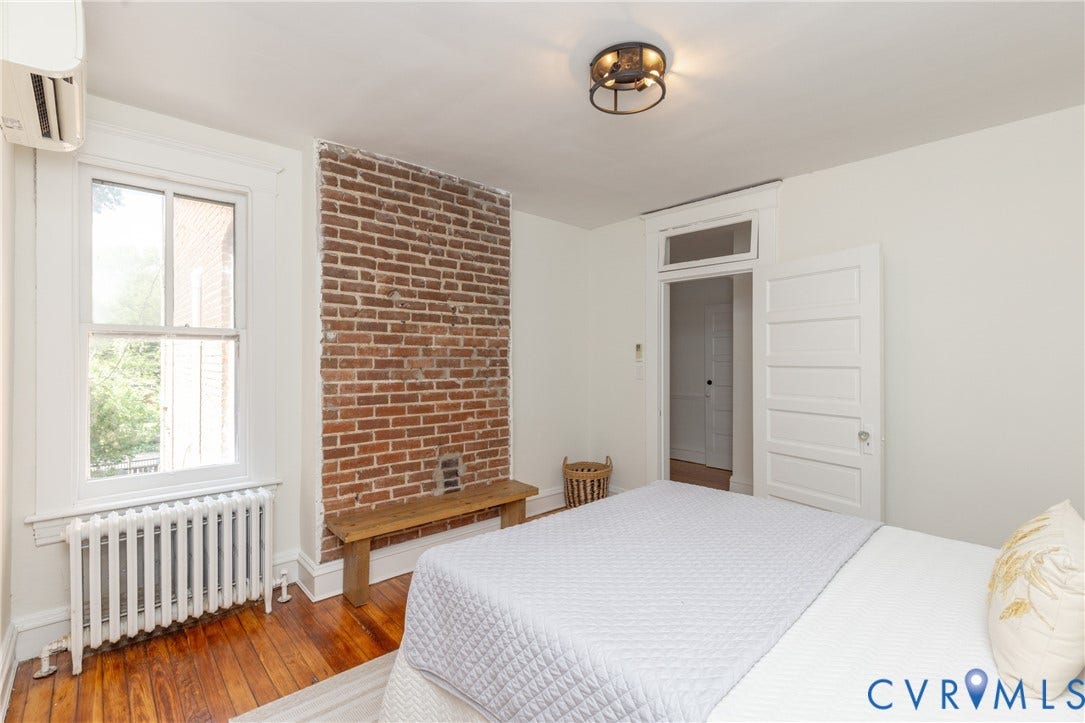 3135 Floyd Avenue, Museum District, Richmond, VA 23221 Exposed brick accent wall, hardwood flooring, and crisp white trim