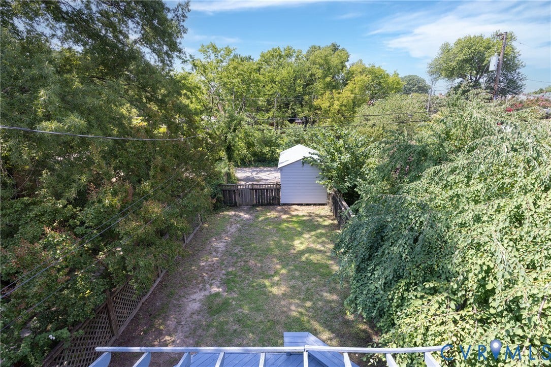 3135 Floyd Avenue, Museum District, Richmond, VA 23221 Expansive backyard featuring a manicured lawn, established privacy landscaping, and a detached storage shed