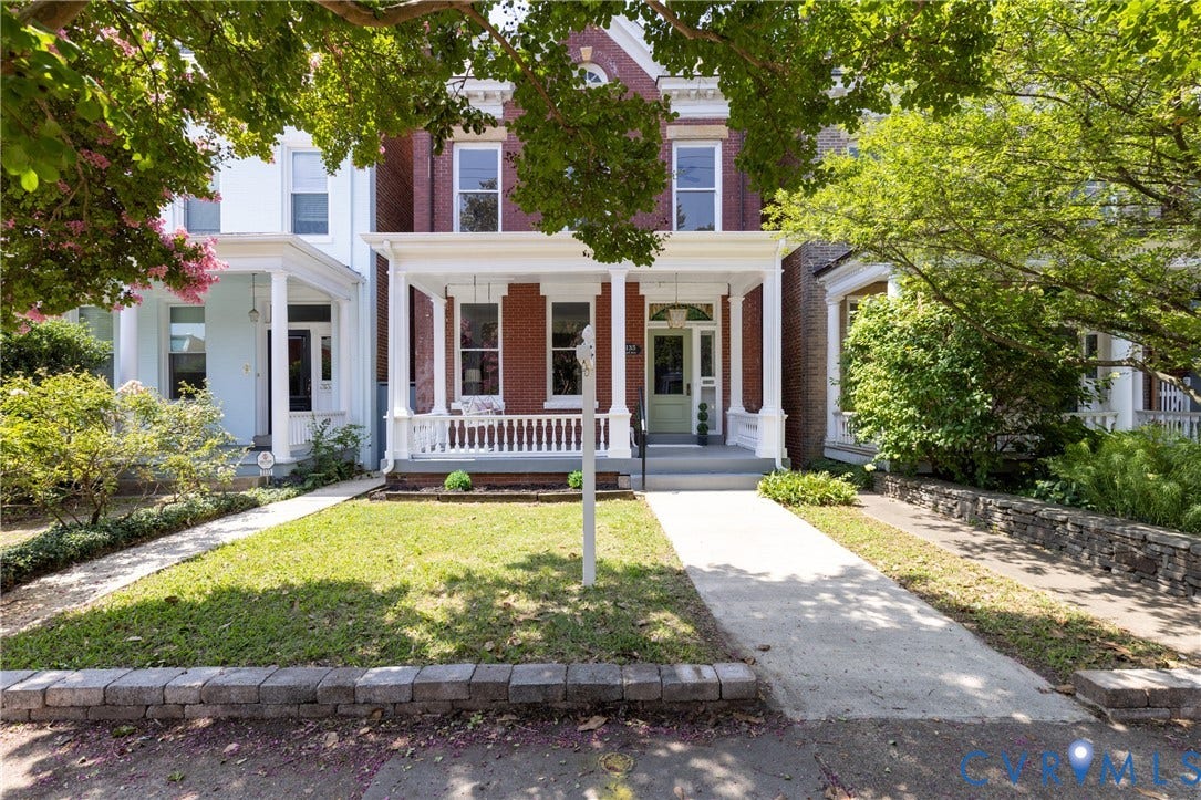 3135 Floyd Avenue, Museum District, Richmond, VA 23221 Red brick facade with white trim and a covered front porch featuring white columns and railing
