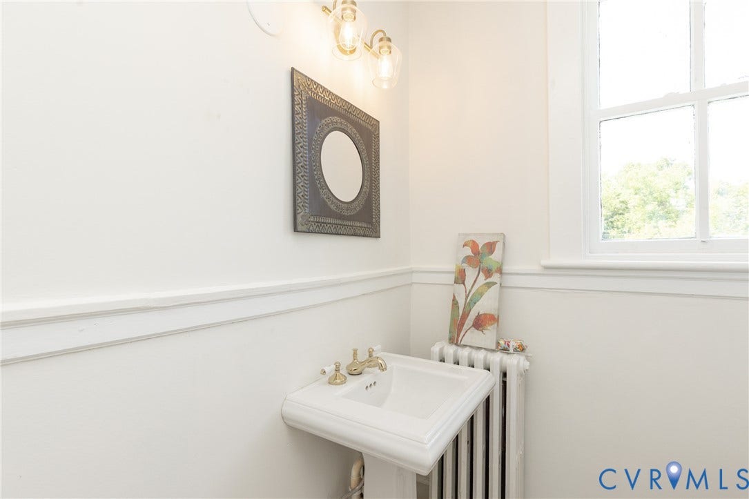 3135 Floyd Avenue, Museum District, Richmond, VA 23221 Pedestal sink with brass-finish faucet fixtures and wall-mounted light fixture
