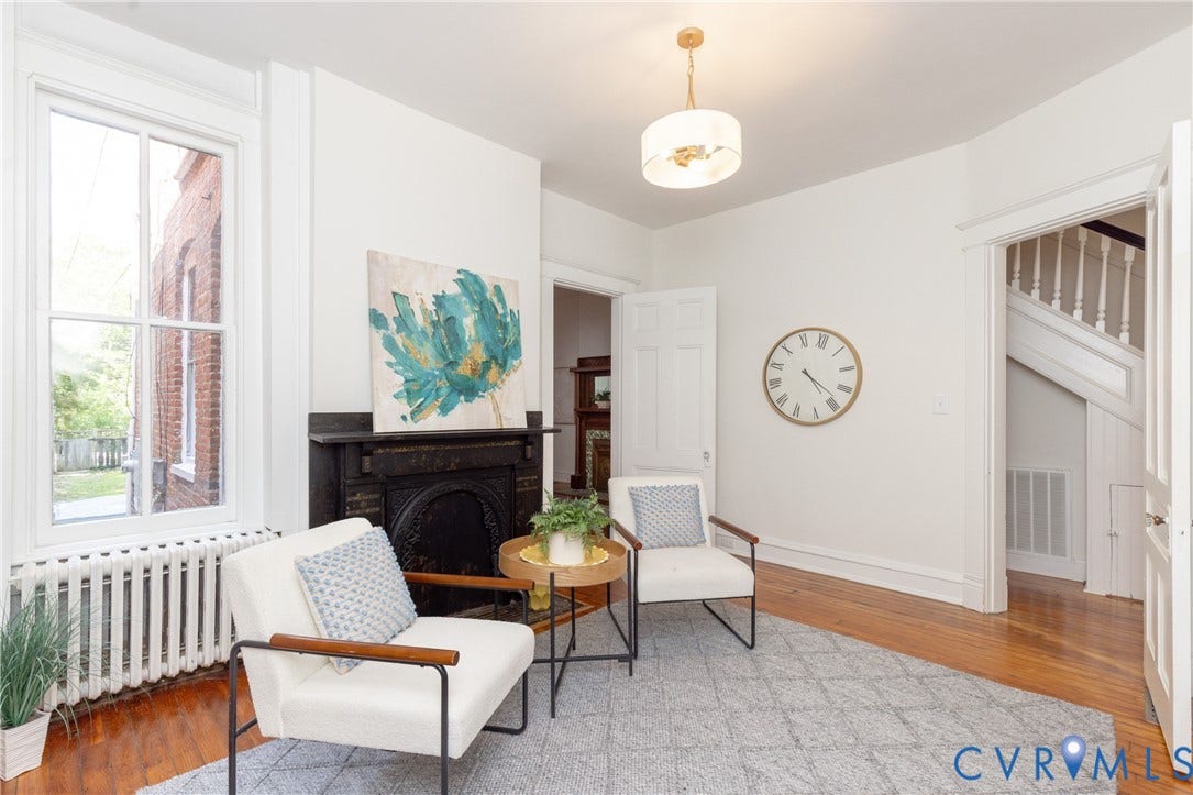 3135 Floyd Avenue, Museum District, Richmond, VA 23221 Hardwood flooring, classic fireplace with detailed ironwork, large windows, ceiling light fixture, and interior staircase with white balusters