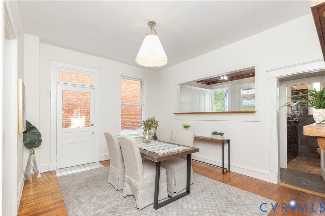 3135 Floyd Avenue, Museum District, Richmond, VA 23221 Dining area featuring wood-finish flooring, white walls, and a prominent open pass-through