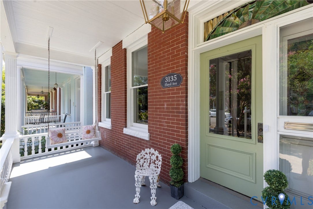3135 Floyd Avenue, Museum District, Richmond, VA 23221 Brick facade featuring a columned porch, decorative transom window, light green entry door with glass panel, and a porch swing