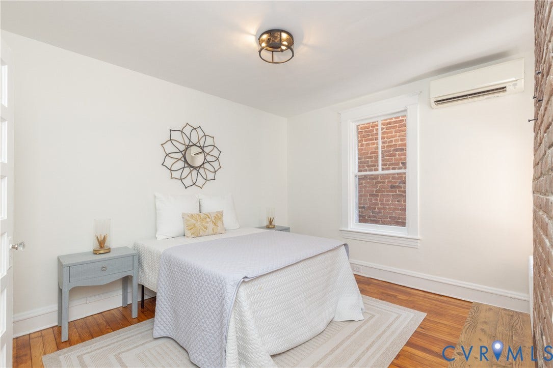 3135 Floyd Avenue, Museum District, Richmond, VA 23221 Bright room featuring wood flooring and a prominent exposed brick wall accent