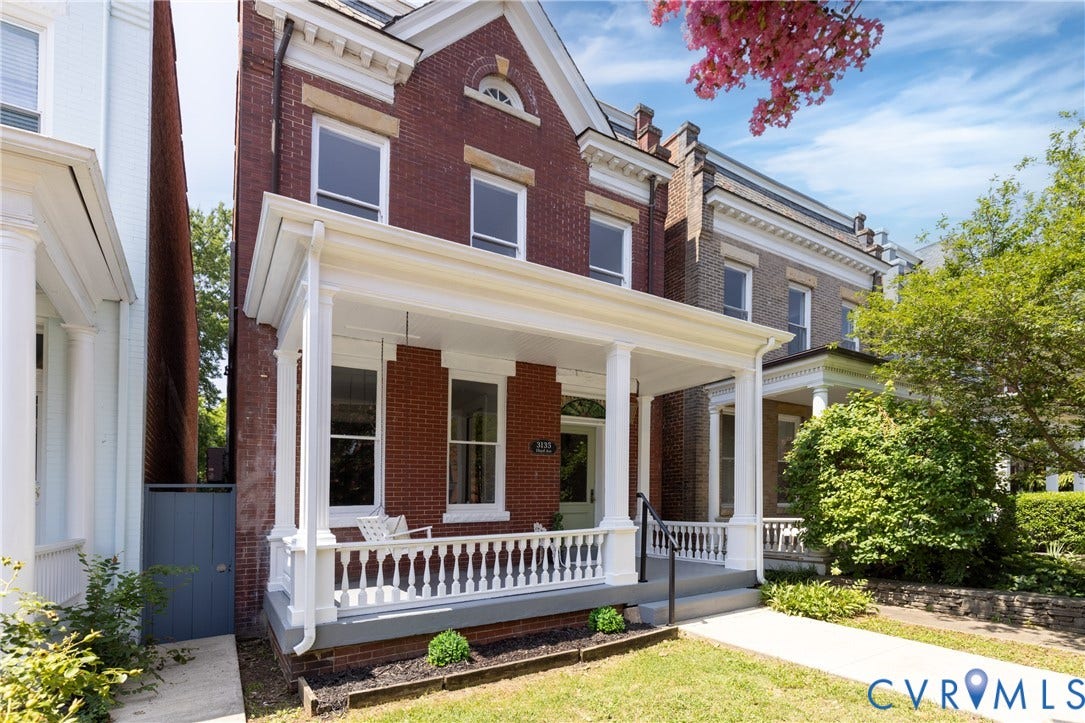 3135 Floyd Avenue, Museum District, Richmond, VA 23221 Brick facade home featuring a covered front porch with white columns and balusters, a concrete walkway, and a manicured lawn