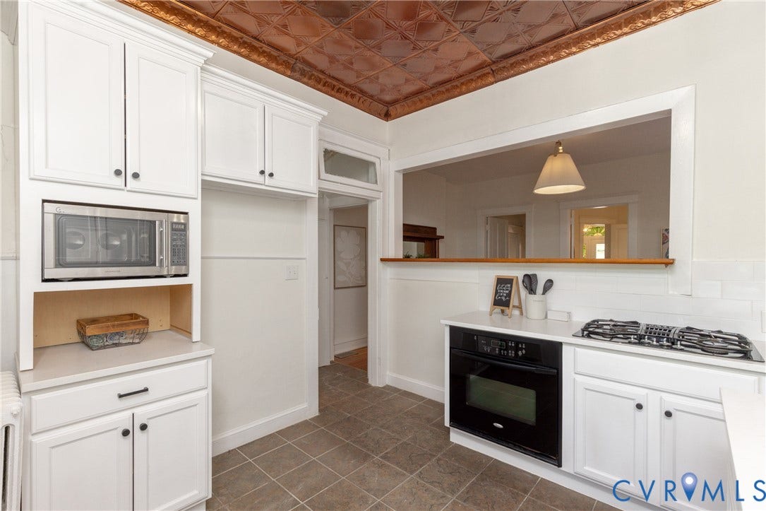 3135 Floyd Avenue, Museum District, Richmond, VA 23221 Kitchen featuring white cabinetry, a built-in stainless steel microwave, a black wall oven, a gas cooktop, and a copper-toned pressed tin ceiling