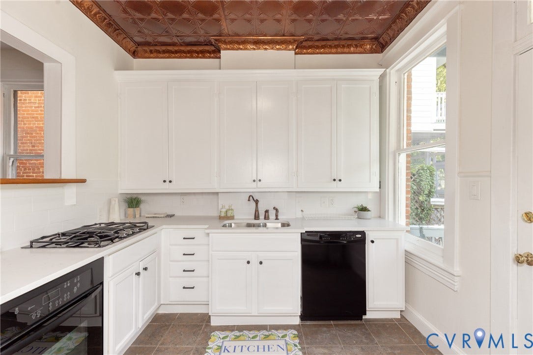 3135 Floyd Avenue, Museum District, Richmond, VA 23221 Kitchen featuring a copper-finish pressed tin ceiling, white shaker-style cabinetry with matte black hardware, integrated gas cooktop, built-in oven, and a single basin sink with an oil-rubbed bronze faucet
