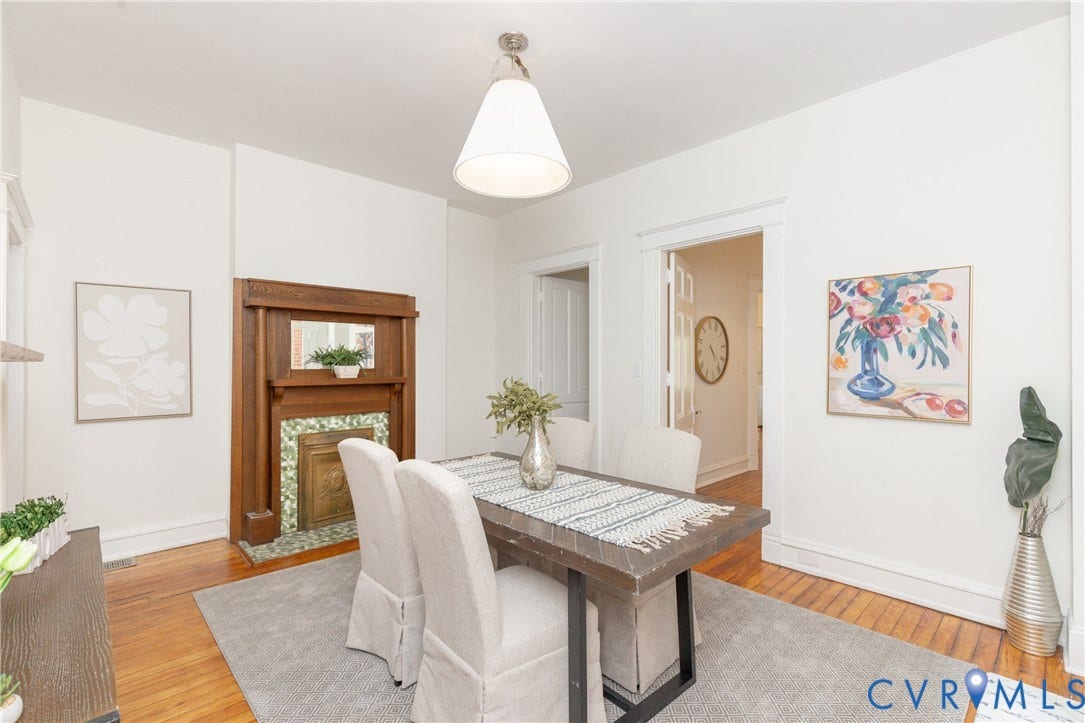 3135 Floyd Avenue, Museum District, Richmond, VA 23221 Dining area featuring wood-finish flooring, a decorative fireplace with a tile surround, and a pendant light fixture