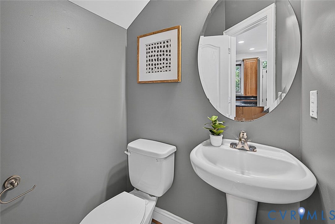 710 S Laurel Street, Oregon Hill, Richmond, VA 23220 Pedestal sink with chrome-finish faucet, circular mirror, and a white toilet