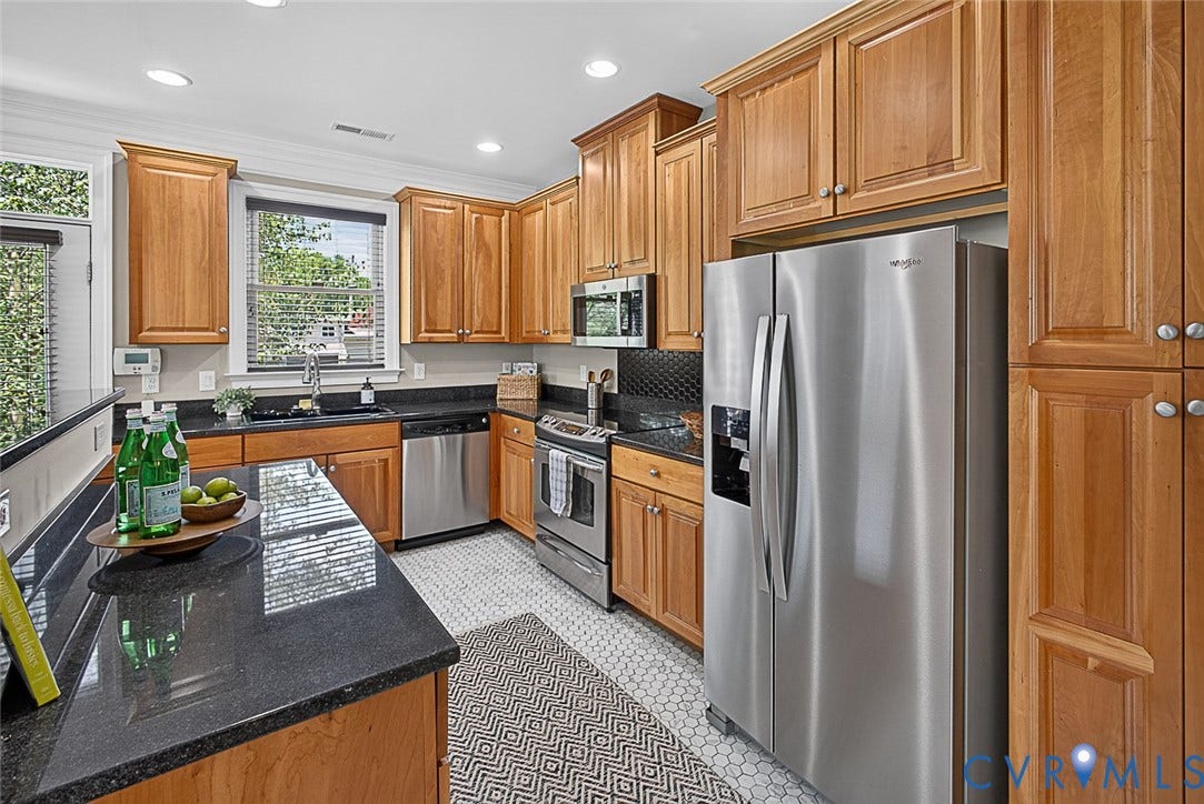 710 S Laurel Street, Oregon Hill, Richmond, VA 23220 Kitchen featuring wood cabinetry, dark countertops, a stainless steel refrigerator, and a tile floor