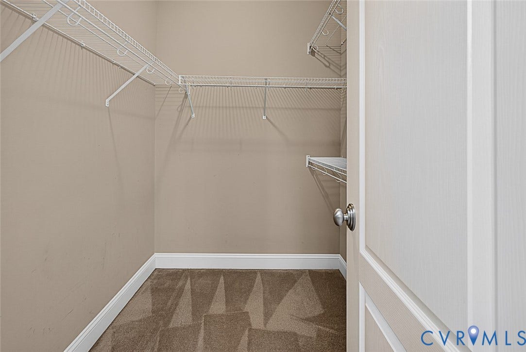 710 S Laurel Street, Oregon Hill, Richmond, VA 23220 Walk-in closet featuring wire shelving, wire hanging rods, neutral wall color, white baseboards, and patterned carpet flooring