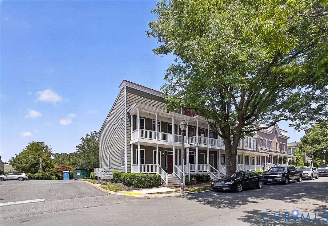 710 S Laurel Street, Oregon Hill, Richmond, VA 23220 Multi-story townhome exterior featuring siding, white columned porches, and a red entry door