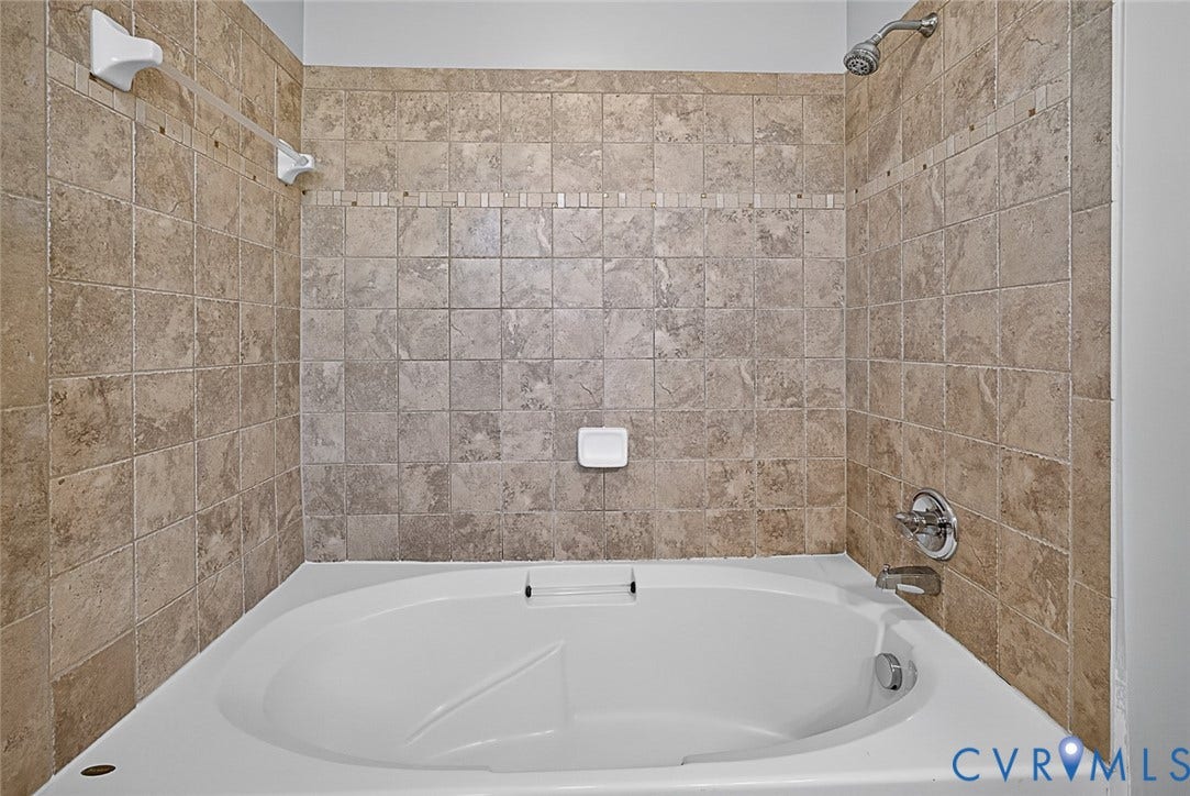 710 S Laurel Street, Oregon Hill, Richmond, VA 23220 Soaking tub with full tile surround featuring a decorative mosaic border