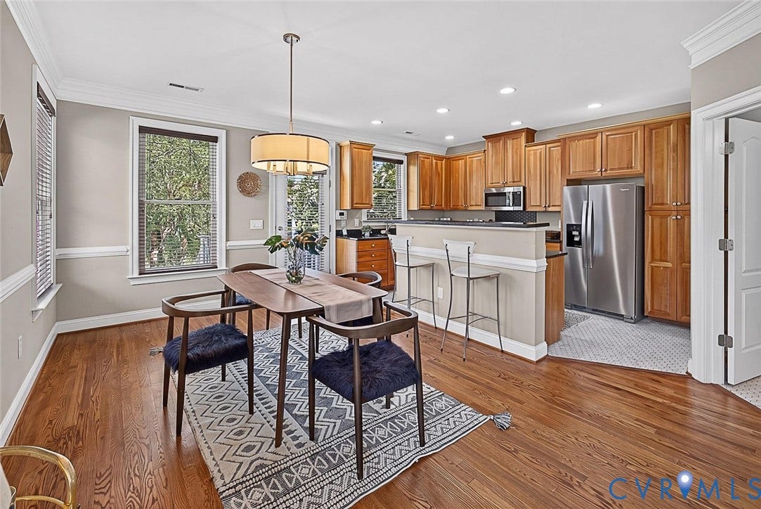 710 S Laurel Street, Oregon Hill, Richmond, VA 23220 Dining area with wood-finish flooring, two windows with blinds, and crown molding