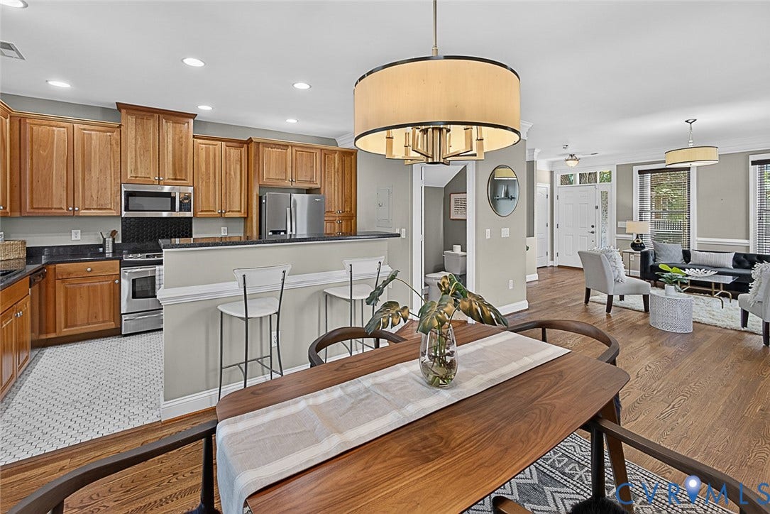 710 S Laurel Street, Oregon Hill, Richmond, VA 23220 Open-concept living area featuring a kitchen with stainless steel appliances, wood cabinetry, and a breakfast bar