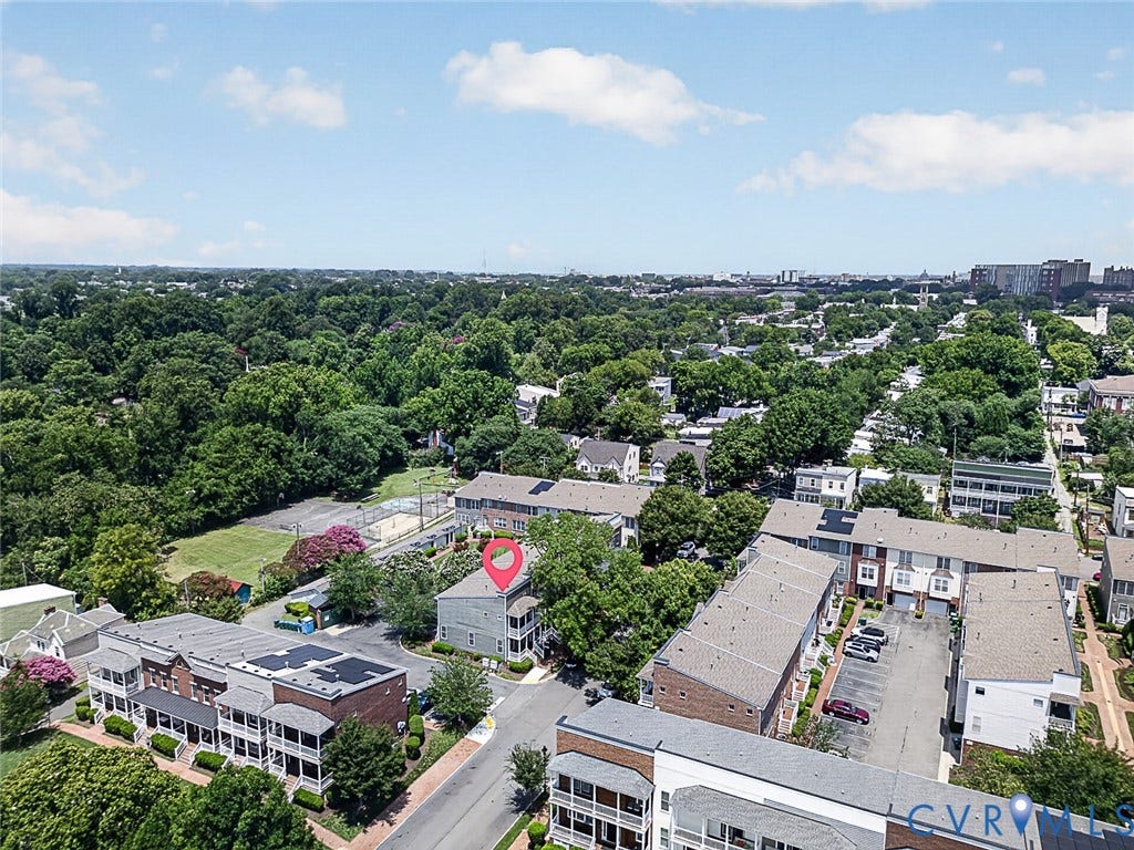 710 S Laurel Street, Oregon Hill, Richmond, VA 23220 Aerial perspective showcasing a residential building with a light-colored exterior, surrounded by mature trees