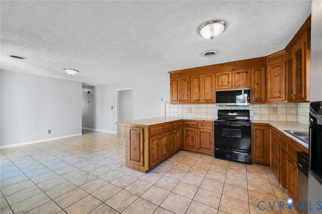 912 Williamsburg Road, Colonial Manor, Colonial Heights, VA 23834 Kitchen featuring wood cabinetry, black appliances, tile flooring, and tile countertops