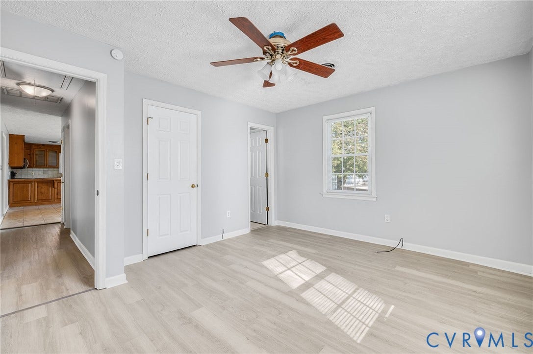 912 Williamsburg Road, Colonial Manor, Colonial Heights, VA 23834 Light wood-finish flooring with a ceiling fan, a window, and light gray wall paint