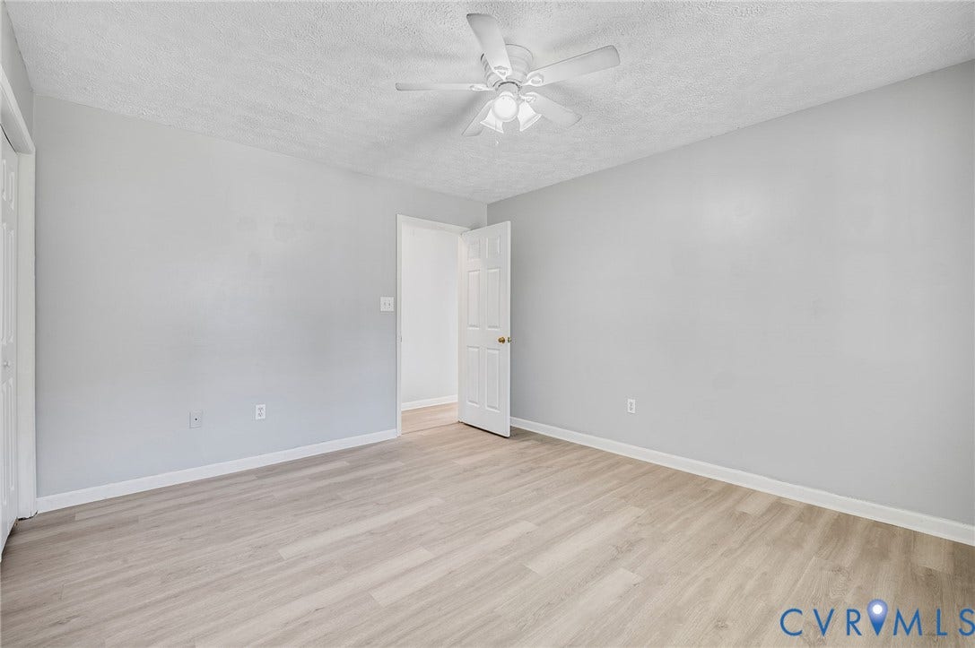 912 Williamsburg Road, Colonial Manor, Colonial Heights, VA 23834 Light-toned wood-finish flooring, white walls, and a ceiling fan with integrated lighting